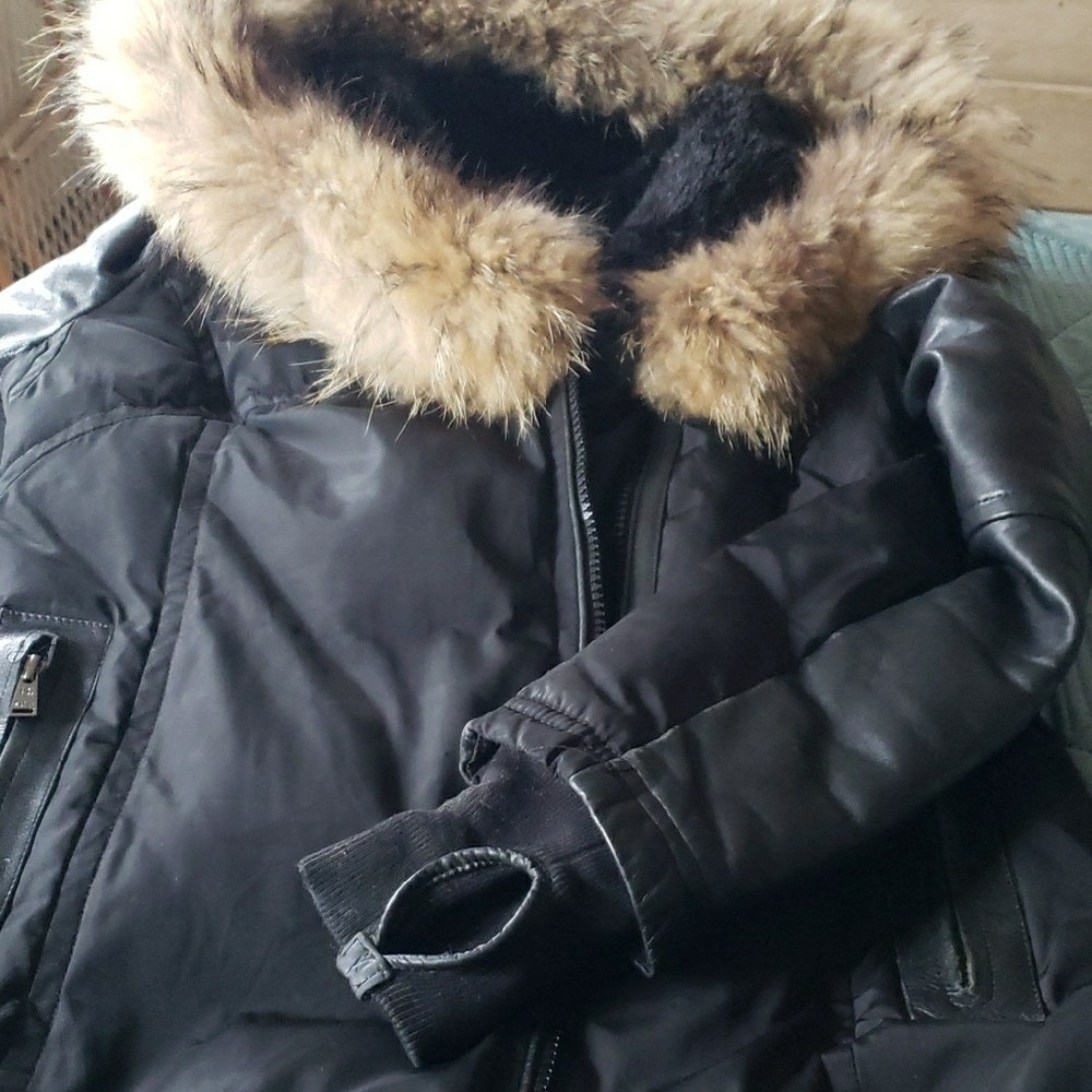 Women's Black Puffer Jacket with leather Trim, brown fur hood.